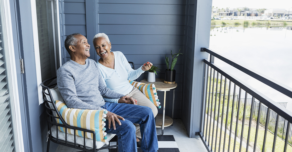 A senior couple sitting on their balcony